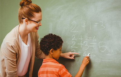 Teacher and student writing on board Hinsdale