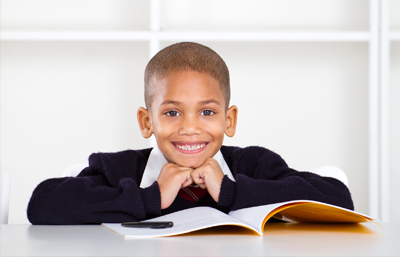 Kid with book smiling